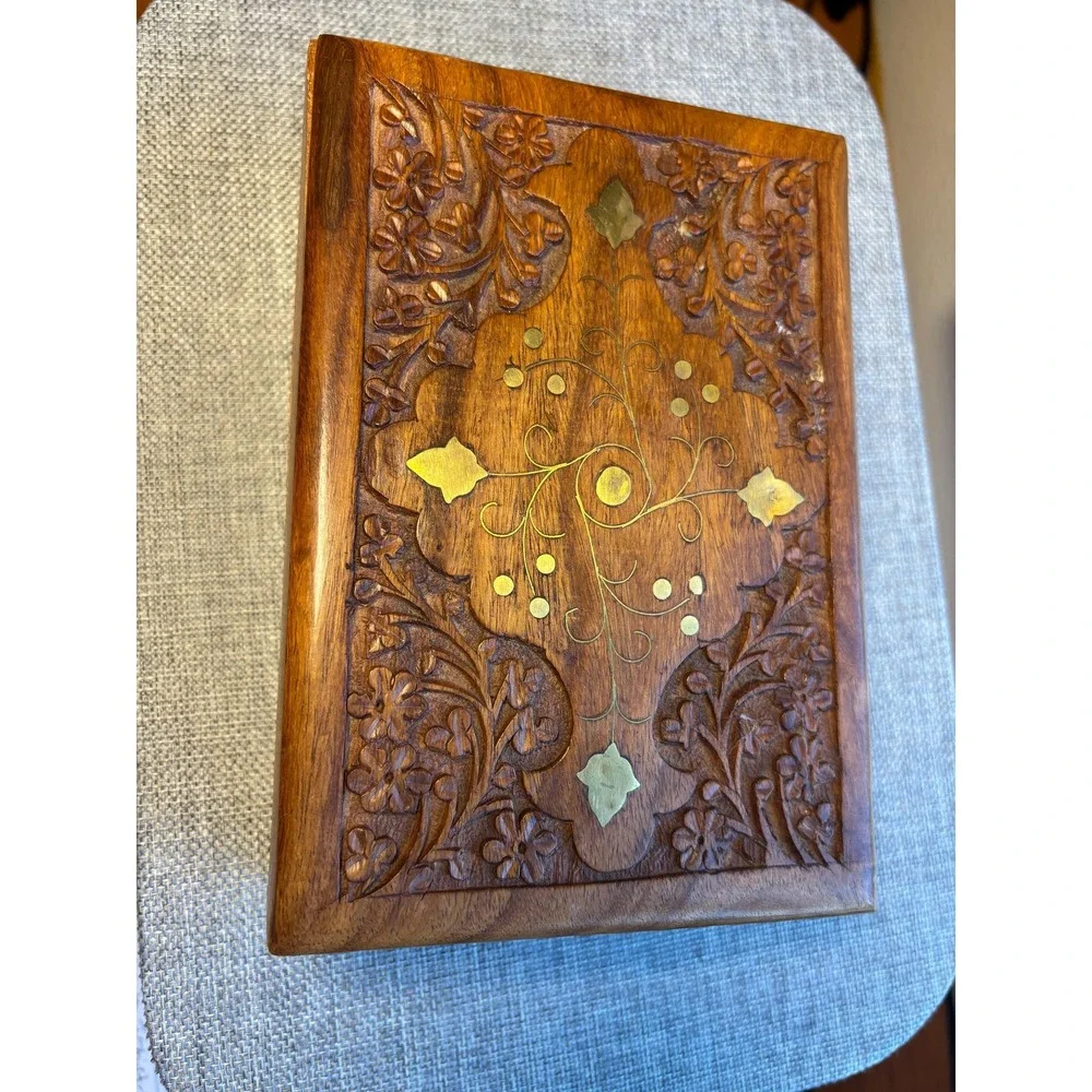 Handmade wooden jewelry box with a brass inlay and hand-carved floral design